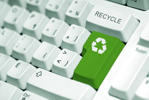 recycle symbol on the computer keyboard in green