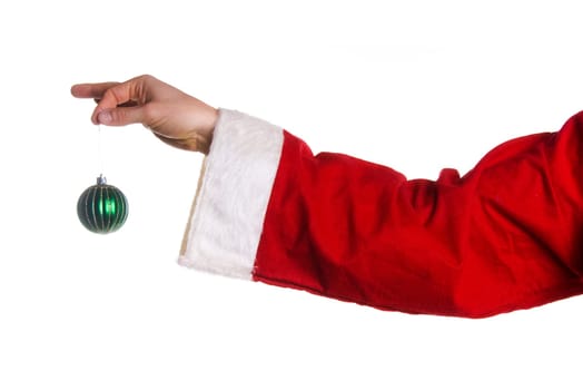 Santa hand holding a green xmas tree ball