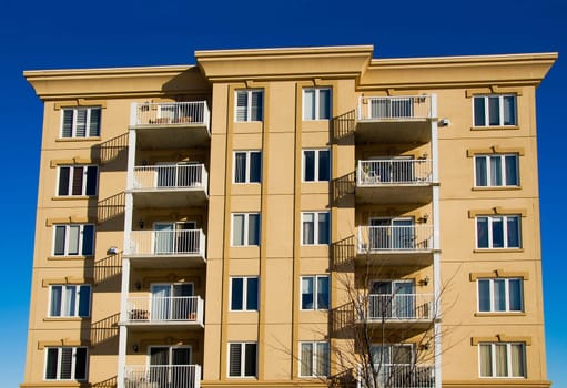 modern beige and brown apartment condos on blue sky