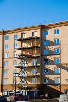 construction modern beige apartment condos on blue sky