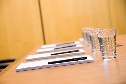 set boardroom with some water glasses and some paper