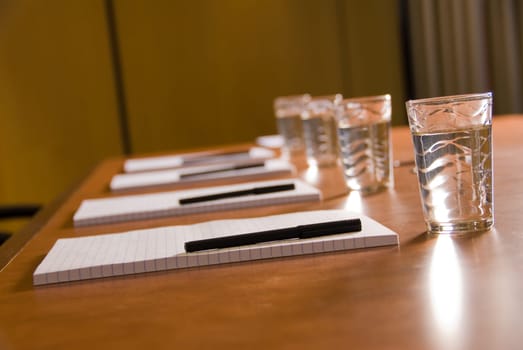 empty board room with water glasses and paper