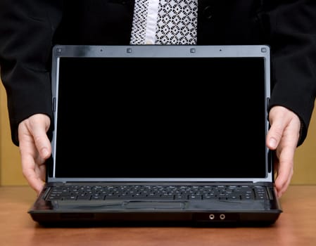 woman holding her laptop closeup on a desk