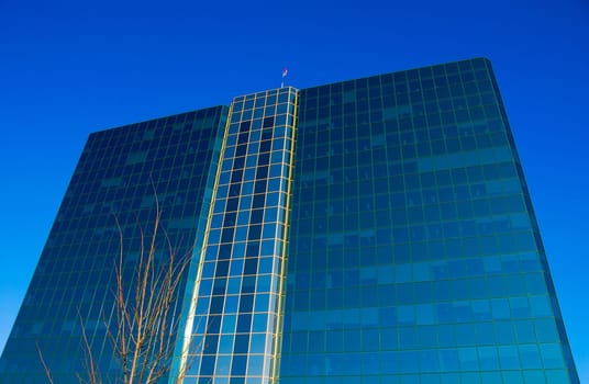 office building of glass on a blue sky
