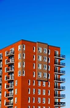 red brick condo complex on a blue sky