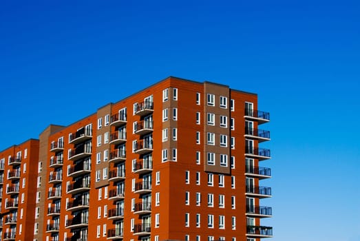 red brick condo complex on a blue sky