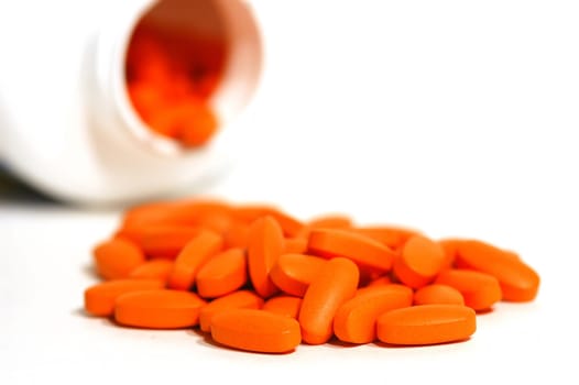 orange vitamin pills out of the bottle