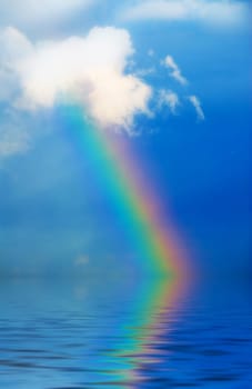 rainbow in the sky during rain on blue