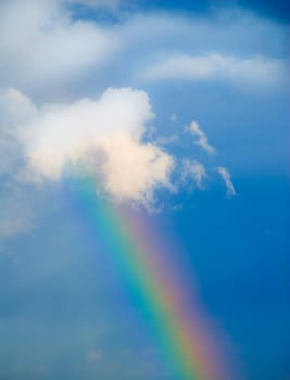 rainbow in the sky during rain on blue