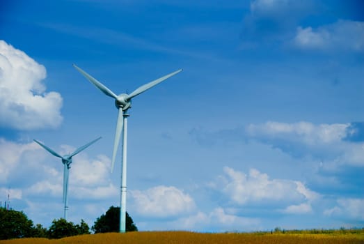 clean energy white wind turbine in wheat field