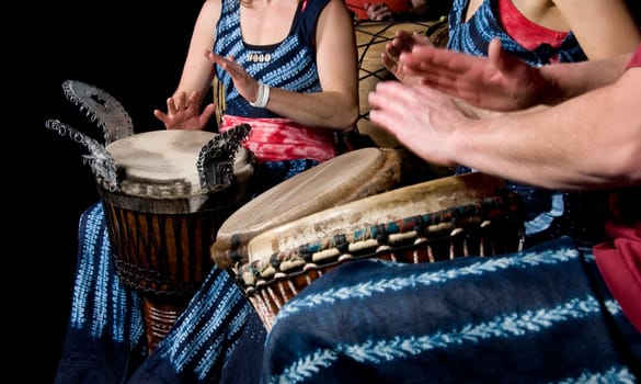 three musicians playing drums in a studio