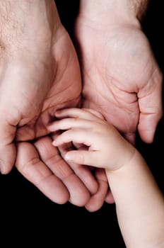 two hands with father and his baby son