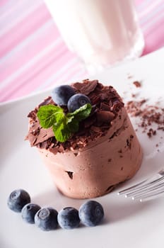Chocolate Moose dessert on a white plate with milk