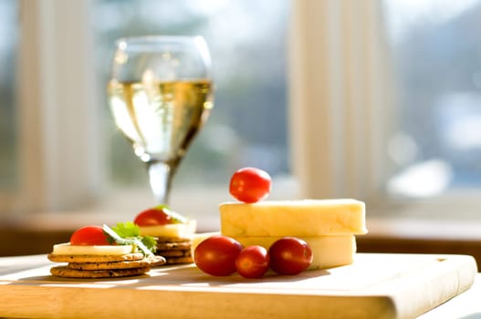 cheese and crackers on a cutting board