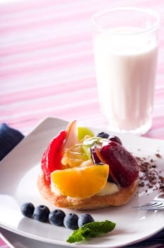 Fruit Tart on a white plate on a table