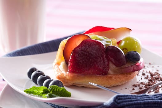 Fruit Tart on a white plate on a table