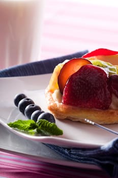 Fruit Tart on a white plate on a table