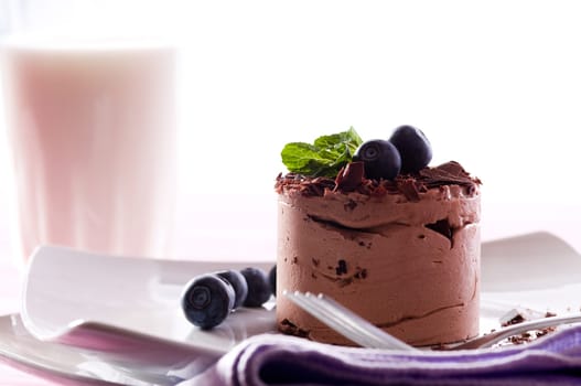 Chocolate Moose dessert on a white plate with milk