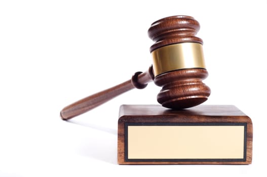 Wooden justice gavel and block with brass