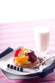 Fruit Tart on a white plate on a table