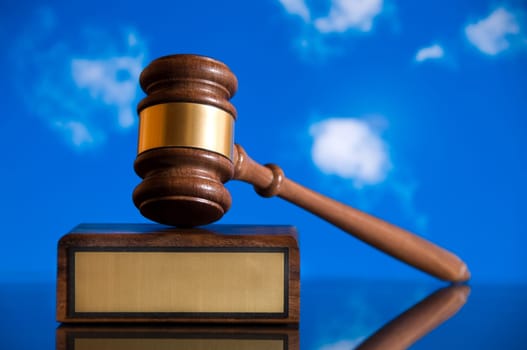 Wooden justice gavel and block with brass