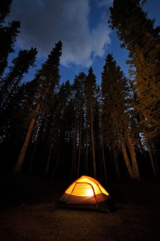 Evening lit tent in camping by nature