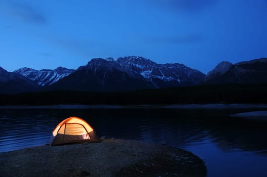 Evening lit tent in camping by nature