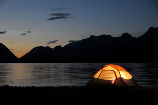 Evening lit tent in camping by nature