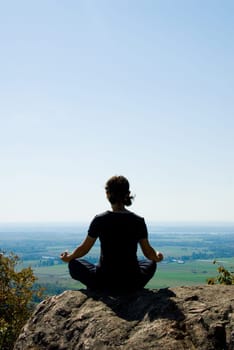 Woman on the top of a mountain relaxing