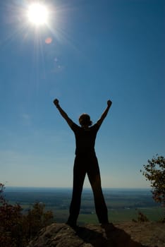 Woman on the top of a mountain happy