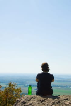 healthy woman on top of a mountain