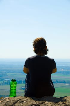 healthy woman on top of a mountain