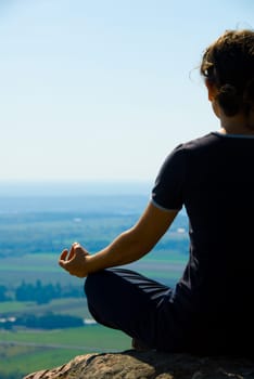 Woman on the top of a mountain meditation