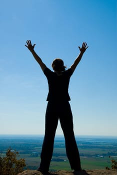 Woman on the top of a mountain happy