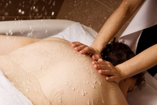 man getting a rain massage by a therapist