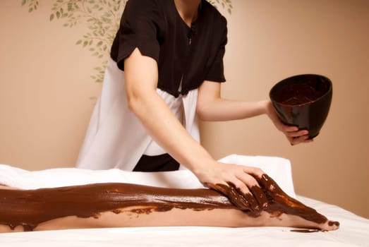 cute woman getting a cacao treatment at a spa