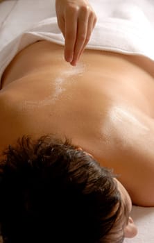 therapist giving a salt treatment to the client