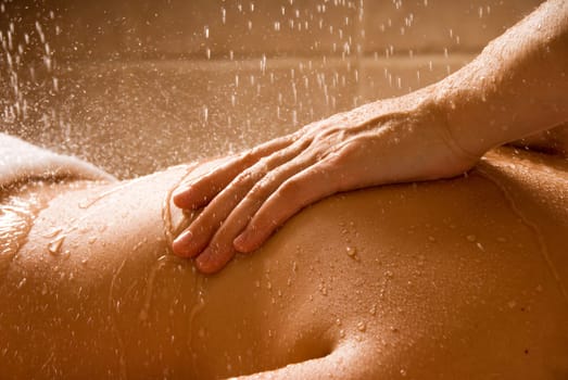 woman getting a rain massage in a day spa