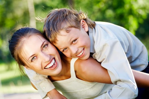 Happy mother holding her cute son and both laughing