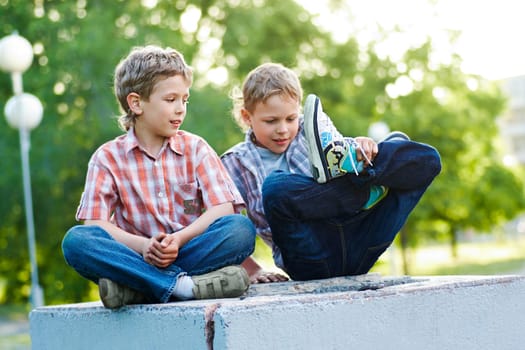 Portrait of two calm kids spending time together outdoors
