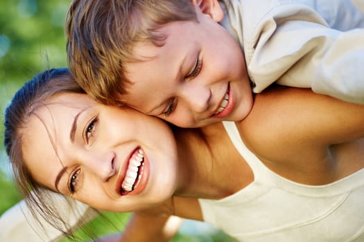 Happy mother holding her cute son and laughing