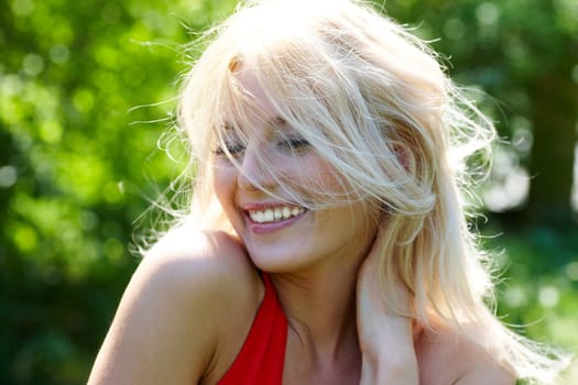 Image of cheerful blonde laughing on summer day
