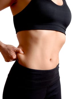 woman in training gear pinching her body fat