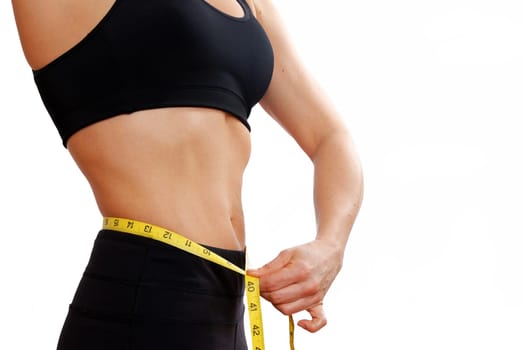 woman with yellow measure tape at her waist