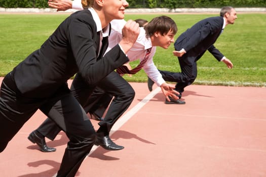 Image of active employees running on sport track