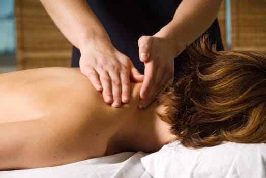 woman in a day spa getting a neck massage