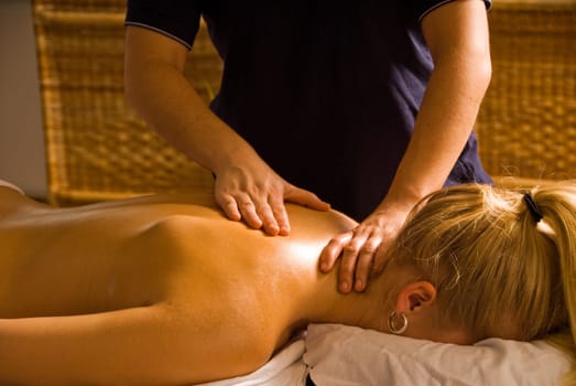 blond woman at a day spa getting a massage