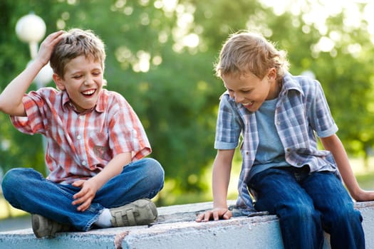 Portrait of two joyful friends having fun outdoors