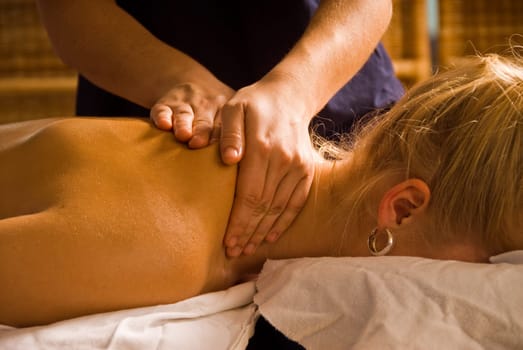 woman at a day spa getting a nice massage from therapist