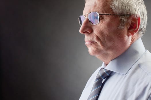 Photo of senior employer on black background
